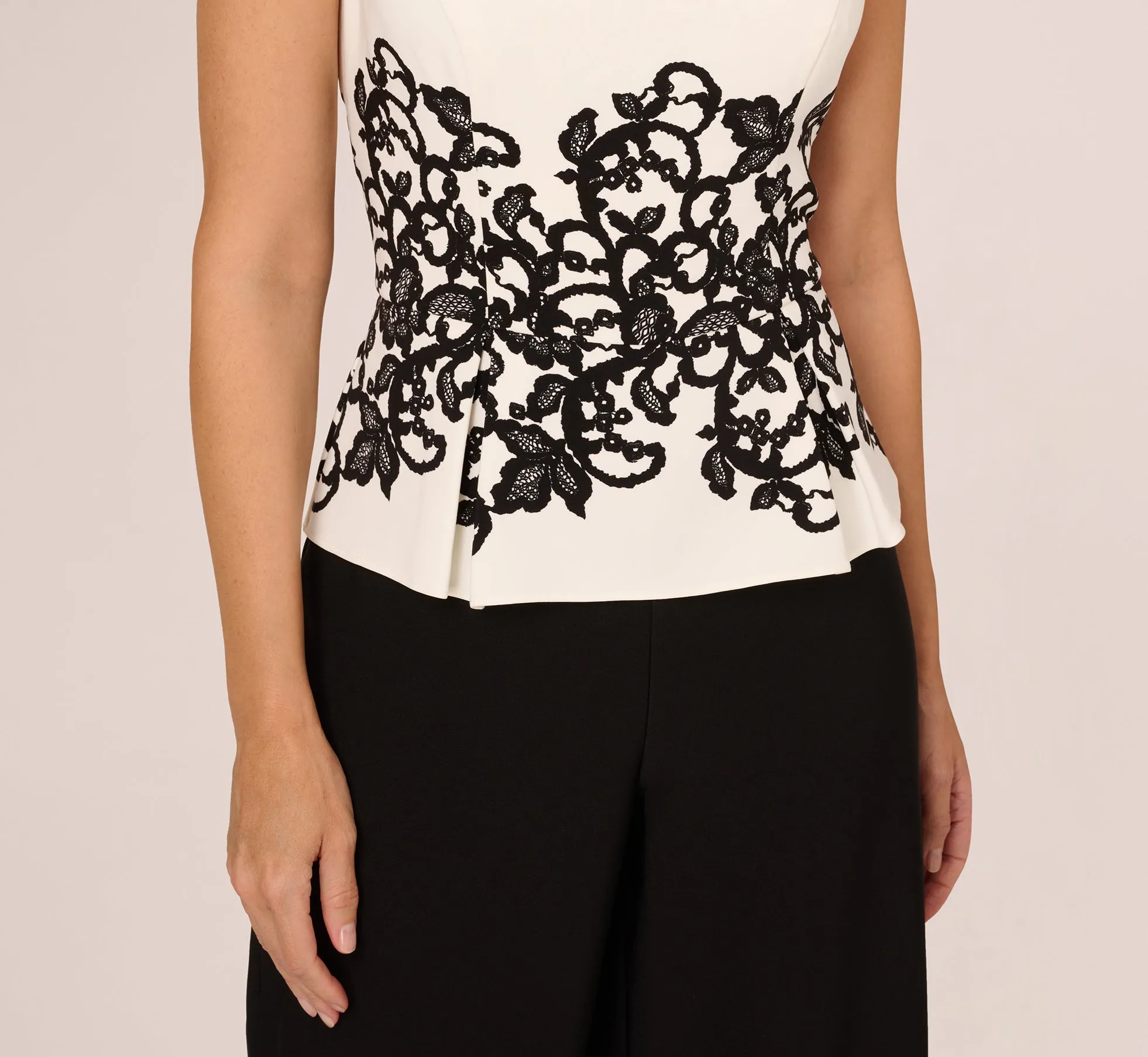 Sleeveless Peplum Jumpsuit With Scroll Lace Details In Ivory Black